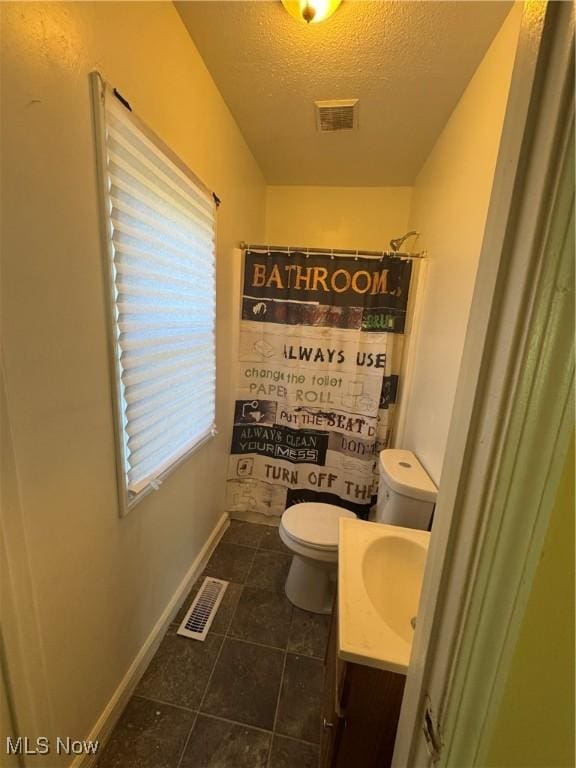 666 Parkwood Rd, Cleveland, OH 44108 - bathroom with vanity, toilet, a textured ceiling, baseboards, and tile patterned flooring
