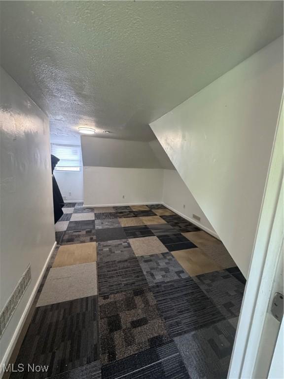 666 Parkwood Rd, Cleveland, OH 44108 - additional living space featuring a textured ceiling