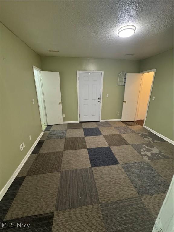 666 Parkwood Rd, Cleveland, OH 44108 - empty room with a textured ceiling and baseboards