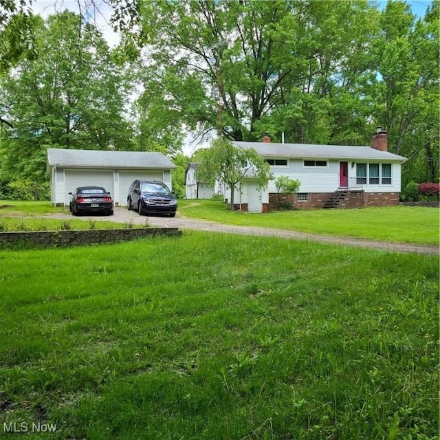 13423 Price St NE, Alliance, OH 44601 - view of green lawn with a detached garage, entry steps, and an outbuilding
