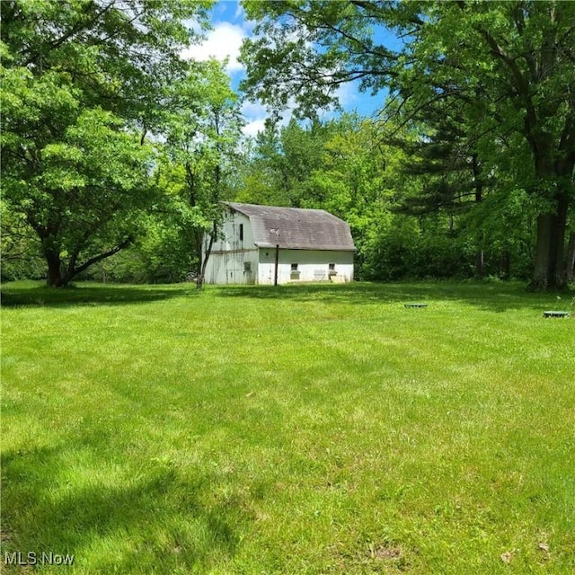 13423 Price St NE, Alliance, OH 44601 - view of green lawn with a barn and an outbuilding