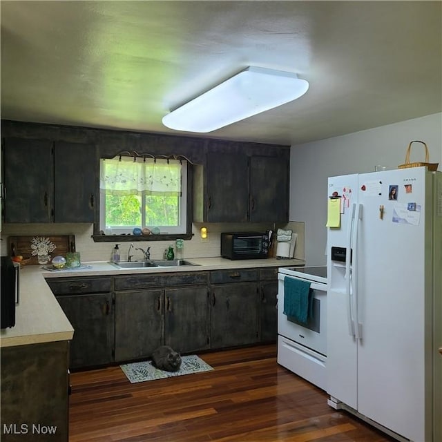 13423 Price St NE, Alliance, OH 44601 - kitchen with white appliances, light countertops, a sink, dark wood finished floors, and decorative backsplash