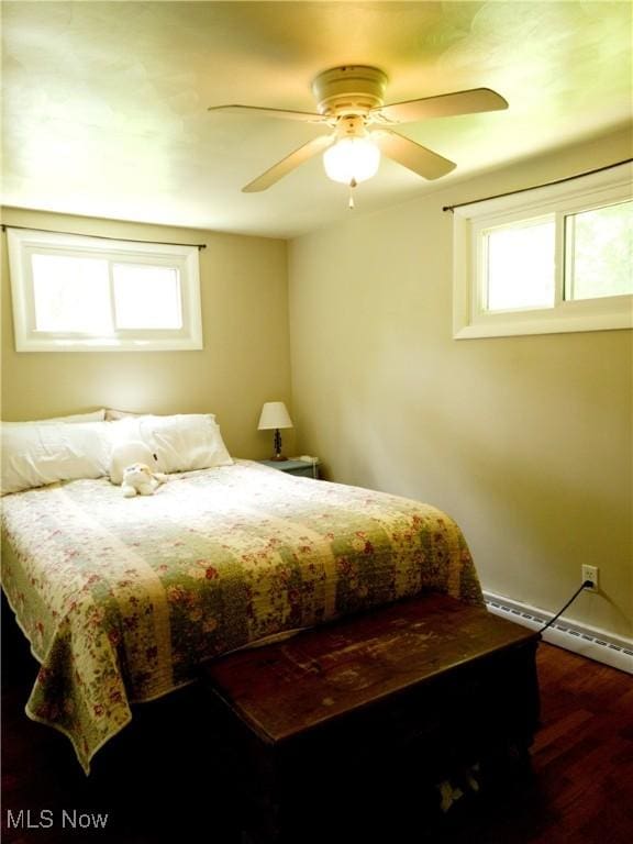 13423 Price St NE, Alliance, OH 44601 - bedroom featuring a baseboard heating unit, wood finished floors, and ceiling fan