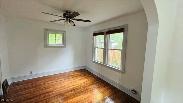 362 E Park Blvd, Akron, OH 44305 - unfurnished room featuring arched walkways, wood finished floors, ceiling fan, and baseboards