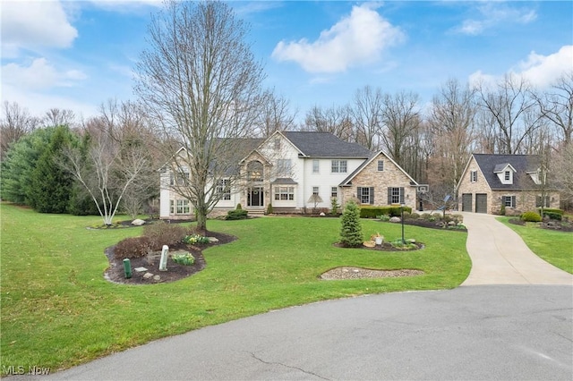 1014 Kings Ridge Blvd, Wadsworth, OH 44281 - traditional-style home with stone siding, a front yard, and a garage