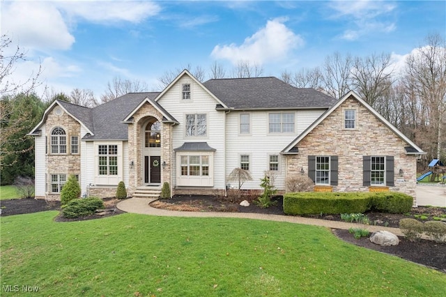 1014 Kings Ridge Blvd, Wadsworth, OH 44281 - view of front of house featuring stone siding, a front lawn, and a shingled roof