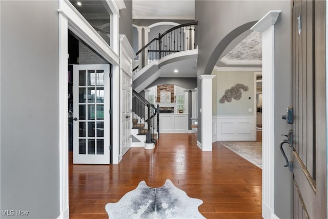 1014 Kings Ridge Blvd, Wadsworth, OH 44281 - entrance foyer with arched walkways, hardwood / wood-style flooring, stairs, ornamental molding, and a wainscoted wall
