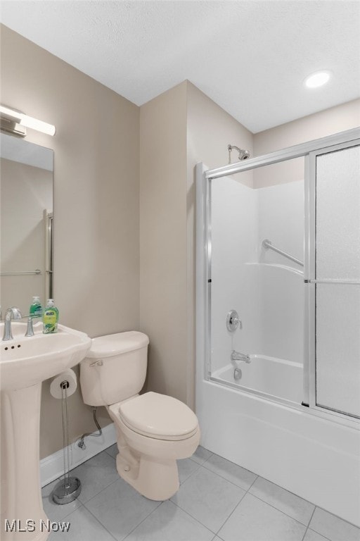 6937 Reynolds Rd, Mentor, OH 44060 - bathroom with toilet, shower / bath combination with glass door, tile patterned flooring, and a sink