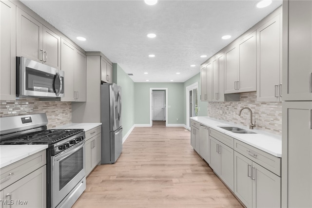 6937 Reynolds Rd, Mentor, OH 44060 - kitchen featuring appliances with stainless steel finishes, a sink, baseboards, recessed lighting, and light wood-type flooring