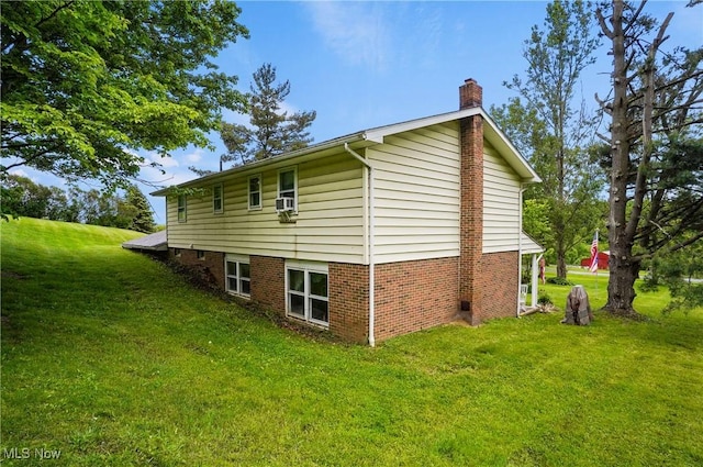 22010 Mountz Rd, Minerva, OH 44657 - view of side of home with a chimney, a lawn, and cooling unit