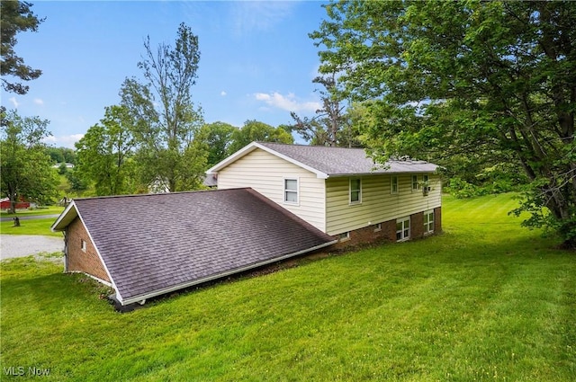 22010 Mountz Rd, Minerva, OH 44657 - view of side of home featuring a yard, a shingled roof, and view of scattered trees