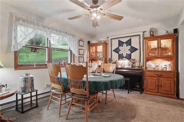 22010 Mountz Rd, Minerva, OH 44657 - dining space with a baseboard heating unit, ceiling fan, carpet flooring, and a textured ceiling