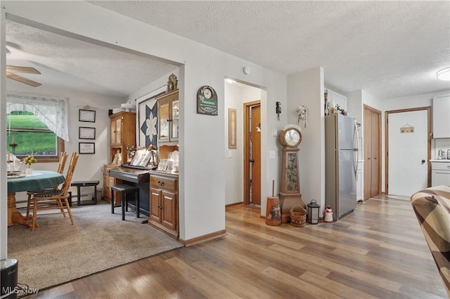 22010 Mountz Rd, Minerva, OH 44657 - office area featuring a textured ceiling, light wood-style flooring, a ceiling fan, a sink, and baseboards