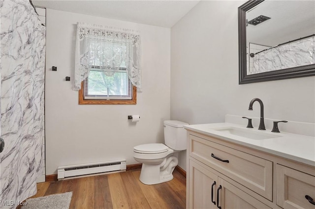 22010 Mountz Rd, Minerva, OH 44657 - full bathroom featuring a baseboard heating unit, vanity, toilet, wood finished floors, and baseboards
