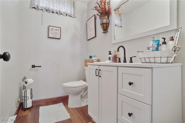 22010 Mountz Rd, Minerva, OH 44657 - half bath with wood finished floors, vanity, toilet, and baseboards