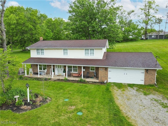 22010 Mountz Rd, Minerva, OH 44657 - view of front facade featuring driveway, covered porch, brick siding, a garage, and a front yard