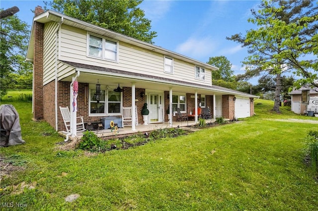 22010 Mountz Rd, Minerva, OH 44657 - view of front of property featuring a chimney, a front lawn, brick siding, and a porch