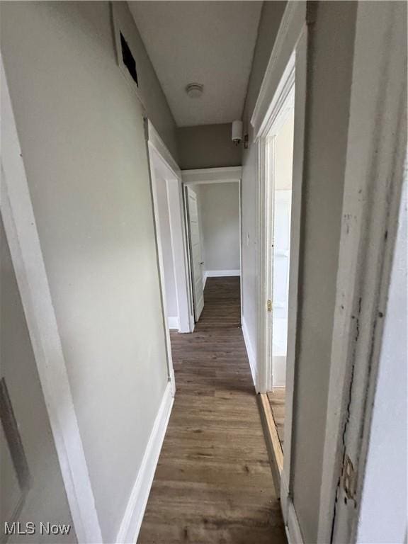 483 E 128th St, Cleveland, OH 44108 - hallway with dark wood-style flooring and baseboards