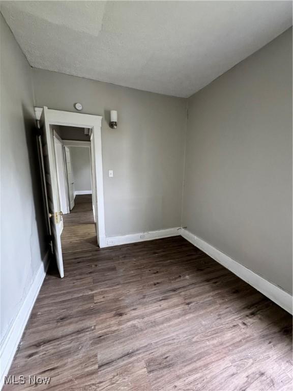 483 E 128th St, Cleveland, OH 44108 - spare room with baseboards and wood finished floors