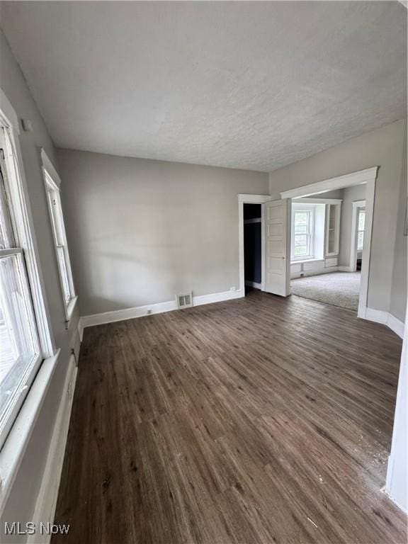 483 E 128th St, Cleveland, OH 44108 - unfurnished room with dark wood-style floors and baseboards