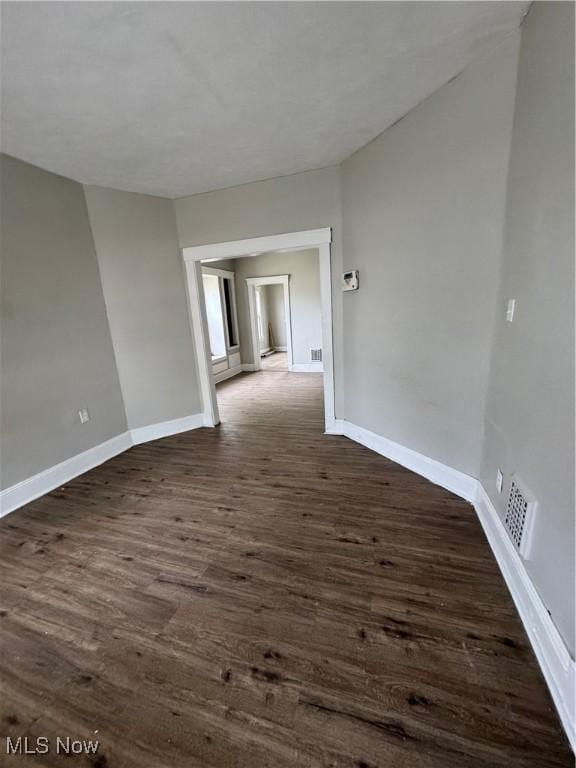 483 E 128th St, Cleveland, OH 44108 - spare room with dark wood finished floors and baseboards