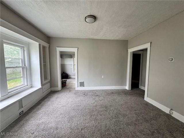 483 E 128th St, Cleveland, OH 44108 - spare room featuring a textured ceiling, carpet, and baseboards