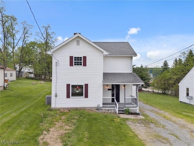 608 Arch St, Salem, OH 44460 - traditional home with covered porch, a shingled roof, a front yard, and central AC
