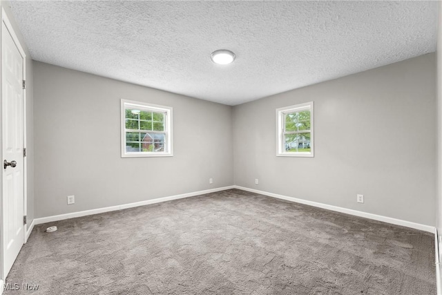 608 Arch St, Salem, OH 44460 - carpeted empty room featuring plenty of natural light, baseboards, and a textured ceiling