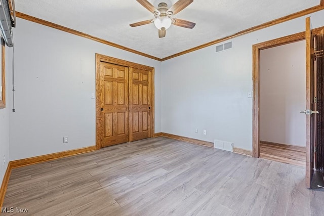 153 Cheyenne Trl, Malvern, OH 44644 - unfurnished bedroom featuring light wood-type flooring, baseboards, crown molding, ceiling fan, and a closet