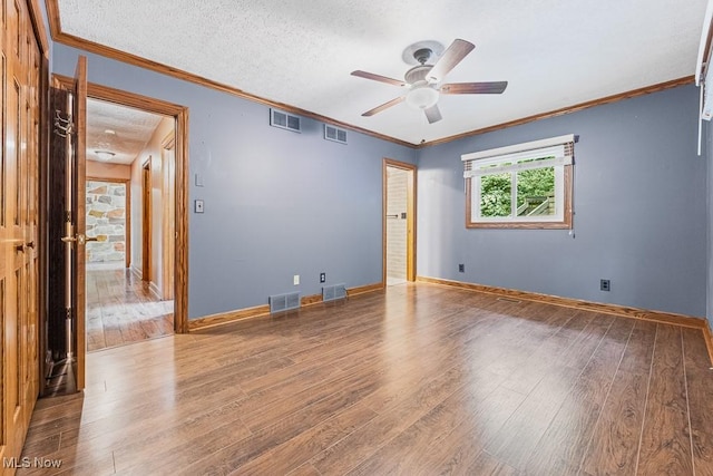 153 Cheyenne Trl, Malvern, OH 44644 - empty room featuring wood finished floors, a ceiling fan, ornamental molding, and a textured ceiling