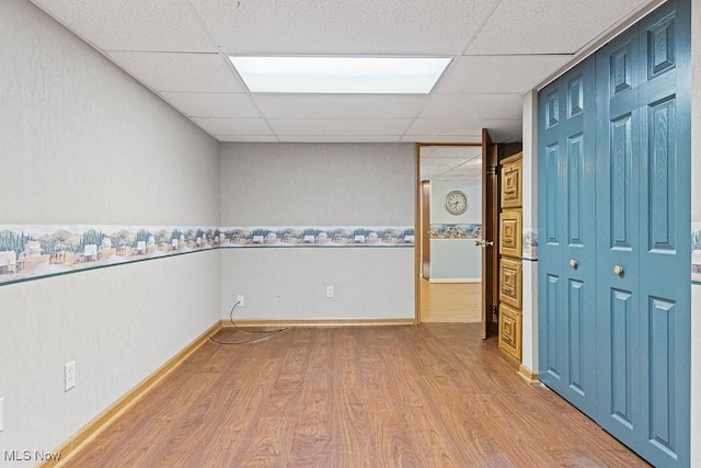 153 Cheyenne Trl, Malvern, OH 44644 - unfurnished room featuring a drop ceiling, wood finished floors, and baseboards