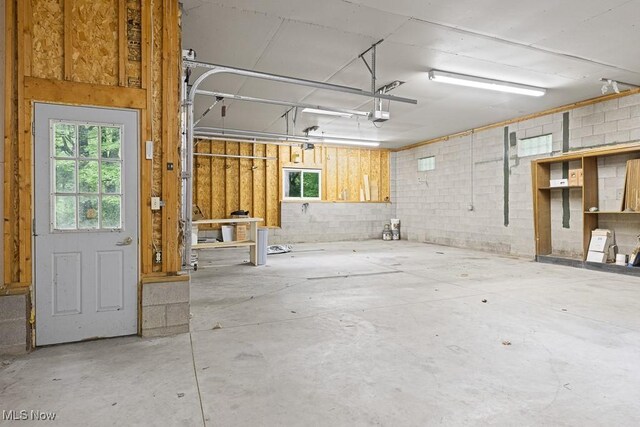 153 Cheyenne Trl, Malvern, OH 44644 - garage featuring a garage door opener and concrete block wall