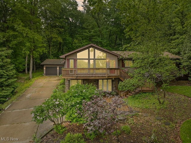 153 Cheyenne Trl, Malvern, OH 44644 - chalet / cabin featuring an outbuilding, a wooden deck, a detached garage, stairs, and a forest view