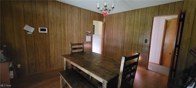 2126 Mctaggart St, Belpre, OH 45714 - dining space with wooden walls, dark wood finished floors, and a chandelier