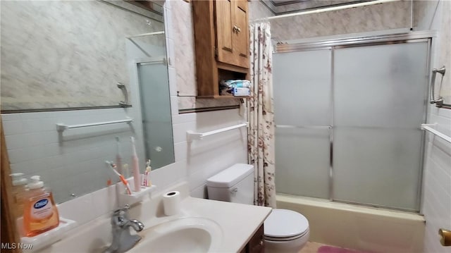 2126 Mctaggart St, Belpre, OH 45714 - bathroom with toilet, bath / shower combo with glass door, vanity, and tile walls
