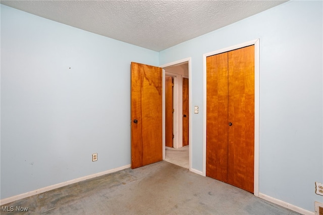 1580 S Hametown Rd, Copley, OH 44321 - unfurnished bedroom with carpet, a closet, baseboards, and a textured ceiling