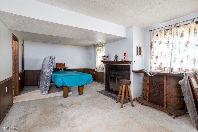 1580 S Hametown Rd, Copley, OH 44321 - playroom with a wainscoted wall, a textured ceiling, billiards, wooden walls, and a fireplace with flush hearth