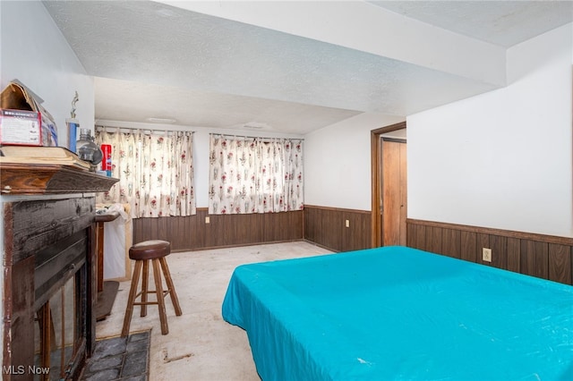 1580 S Hametown Rd, Copley, OH 44321 - bedroom with a wainscoted wall, a fireplace, a textured ceiling, and wooden walls