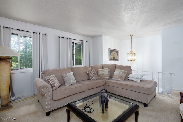 1580 S Hametown Rd, Copley, OH 44321 - living room featuring light colored carpet, a textured ceiling, a chandelier, and baseboards