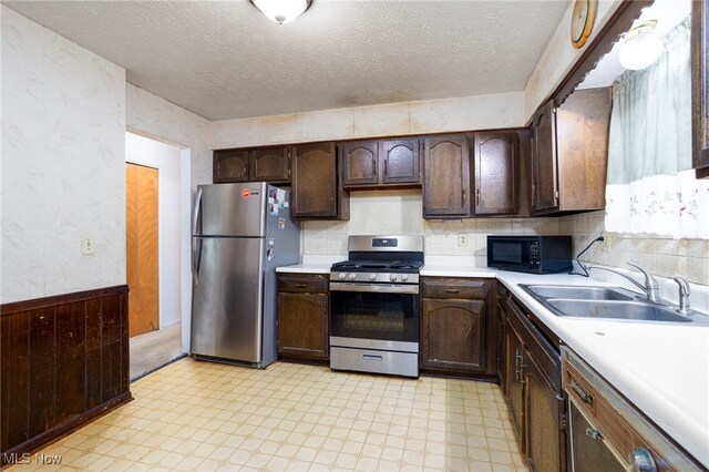 1580 S Hametown Rd, Copley, OH 44321 - kitchen featuring stainless steel appliances, a sink, light floors, light countertops, and dark brown cabinets