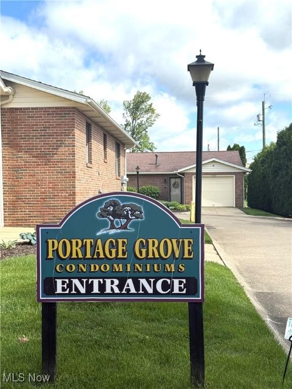 2518 Portage Grove Ct, Wooster, OH 44691 - community / neighborhood sign with concrete driveway, a detached garage, and a yard