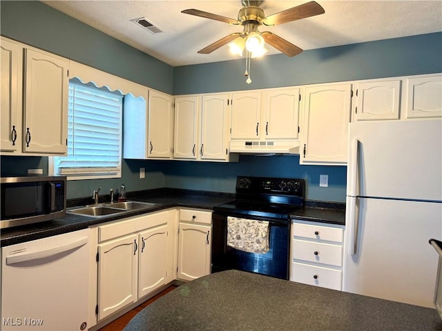 2518 Portage Grove Ct, Wooster, OH 44691 - kitchen featuring white appliances, a sink, under cabinet range hood, dark countertops, and white cabinetry