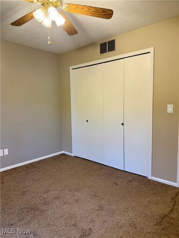 2518 Portage Grove Ct, Wooster, OH 44691 - unfurnished bedroom featuring carpet floors, baseboards, a closet, and a ceiling fan