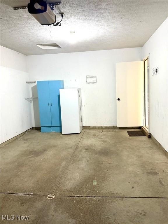 2518 Portage Grove Ct, Wooster, OH 44691 - garage featuring freestanding refrigerator and a garage door opener
