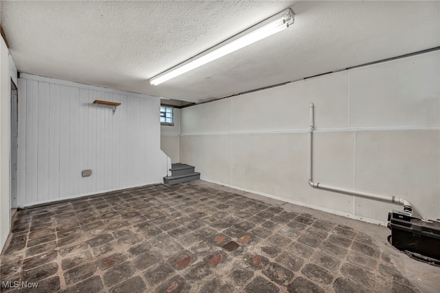 21650 Wilmore Ave, Euclid, OH 44123 - basement with stairs, a textured ceiling, and wood walls