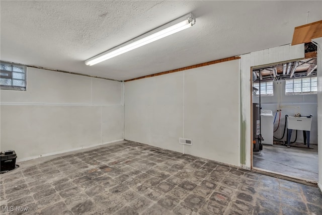 21650 Wilmore Ave, Euclid, OH 44123 - basement with plenty of natural light, a textured ceiling, washer / clothes dryer, and a sink
