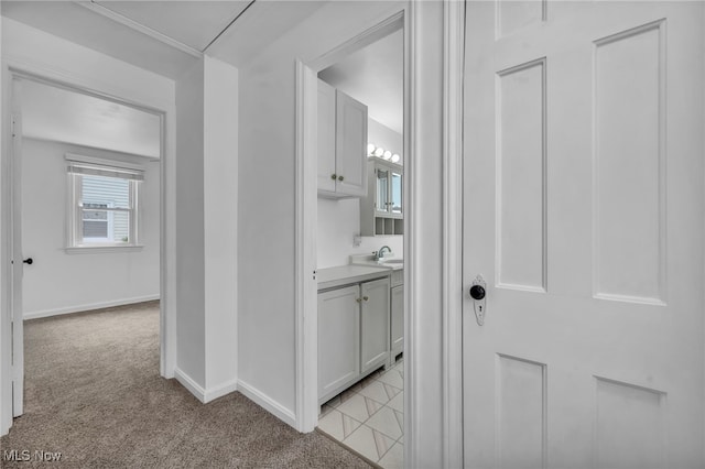 21650 Wilmore Ave, Euclid, OH 44123 - corridor featuring light carpet, baseboards, and a sink