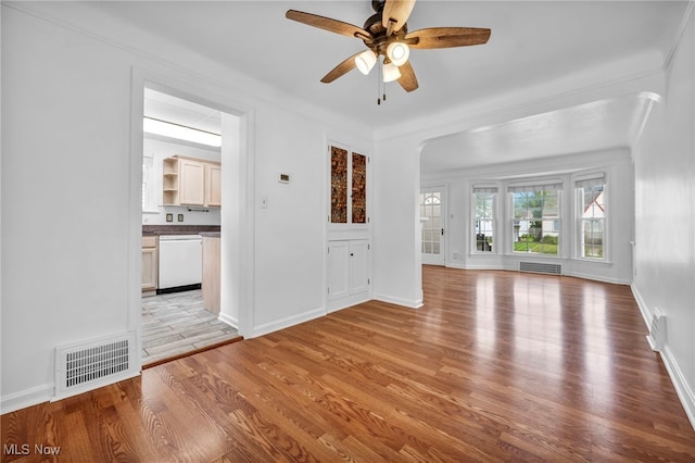 21650 Wilmore Ave, Euclid, OH 44123 - unfurnished living room with light wood-style flooring, arched walkways, ceiling fan, and baseboards