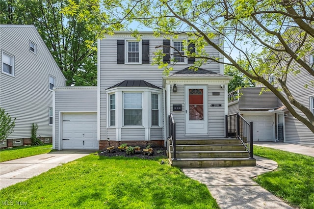 21650 Wilmore Ave, Euclid, OH 44123 - view of front of house with an attached garage, concrete driveway, and a front yard