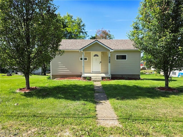 719 Clark St, Philo, OH 43771 - view of front facade with a front yard and roof with shingles